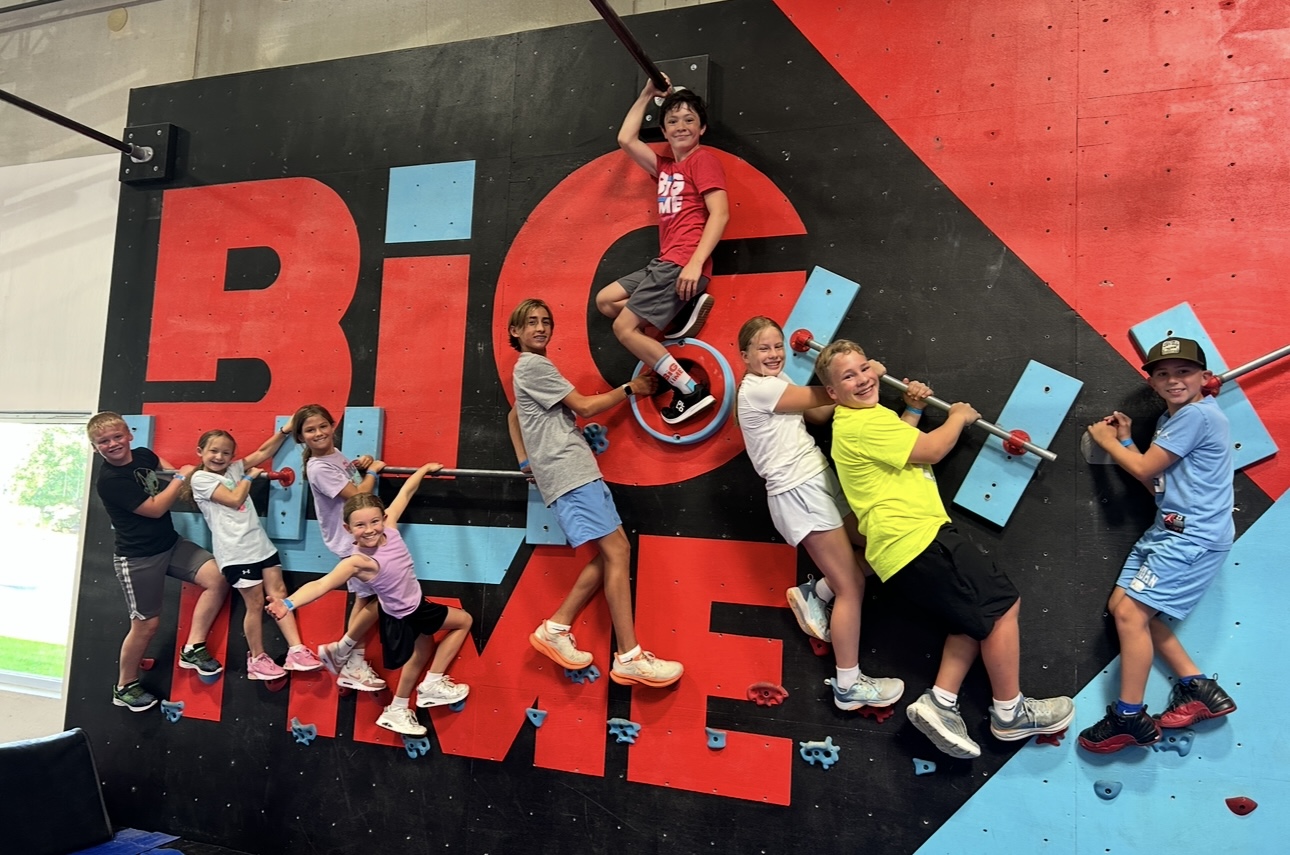 Kids at ninja camp tackling the obstacle course