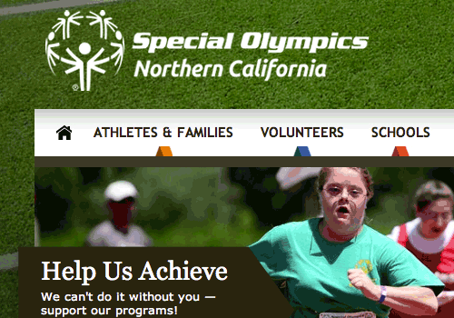 A close-up screenshot of the top-left quadrant of the Special Olympics of Northern California's website, that was created from this work. The logo is in the top left in white, atop a deep green image of astroturf. The navigation bar is white, and an athlete running in a track event is shown in the foreground of the hero image just beneath the navigation. "Help us Achieve" is the description of that hero module, layered atop a black background in white text within a ribbon graphic that sits atop the image.
