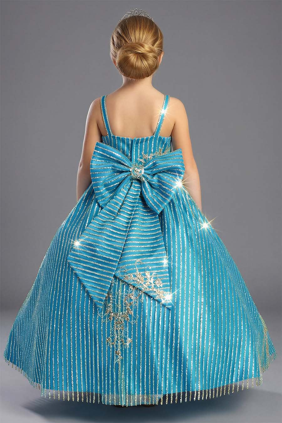 A shiny glittered dress for girls in a Turquoise color with gold glitter and sequins. The back has a large removable bow with the same fabric as the dress