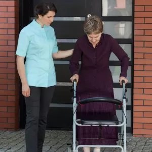 BIOKINETIX expert instructing a woman with a walker