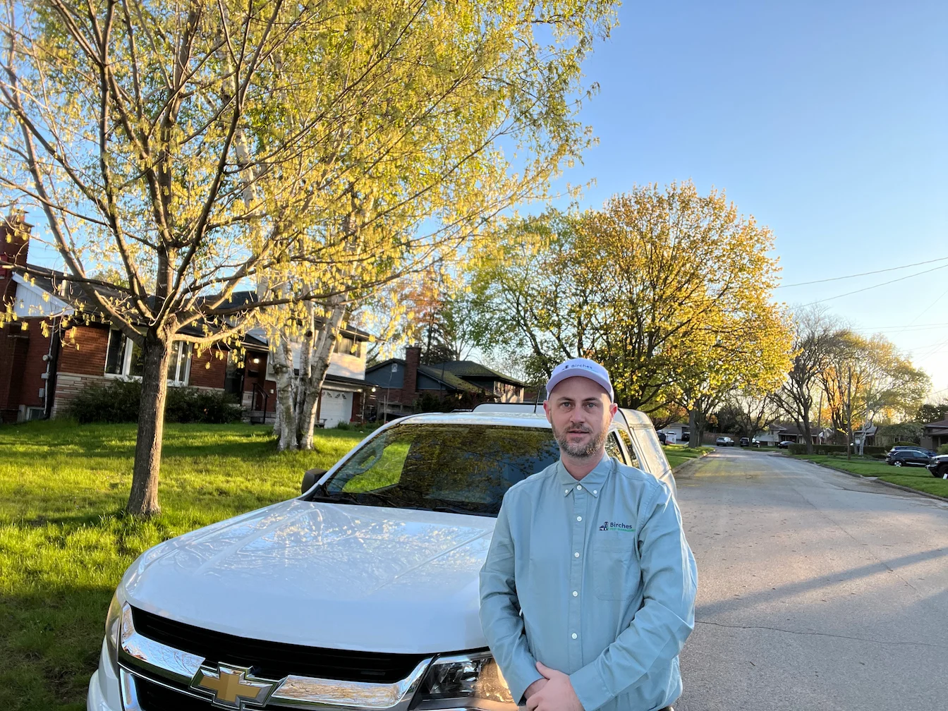 Birches Tech Management Technician Standing in front of Service Truck in Neighborhood before a treatment