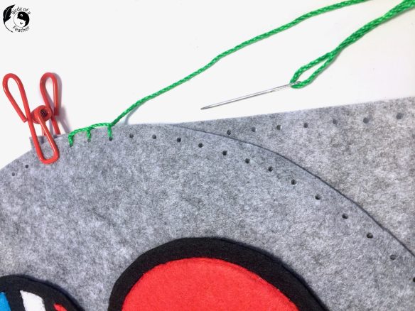 Hand stitching around felt applique