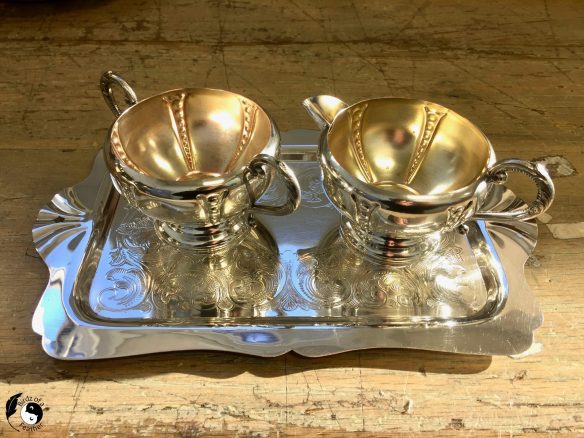 clean and sparkling cream and sugar set sitting on silver tray; how to remove tarnish from silver