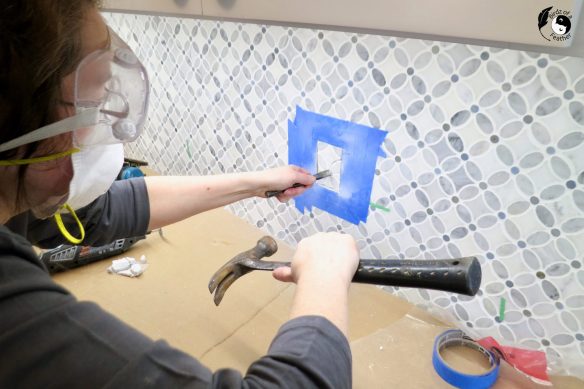 Chisel out the tile after cutting to add an outlet