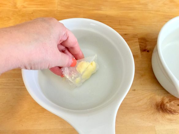 Hand butter the inside of the dishes