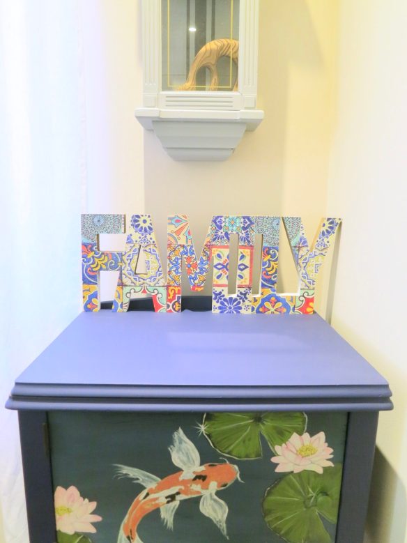 how to decoupage wood family sign on top of painted cabinet with koi fish on front