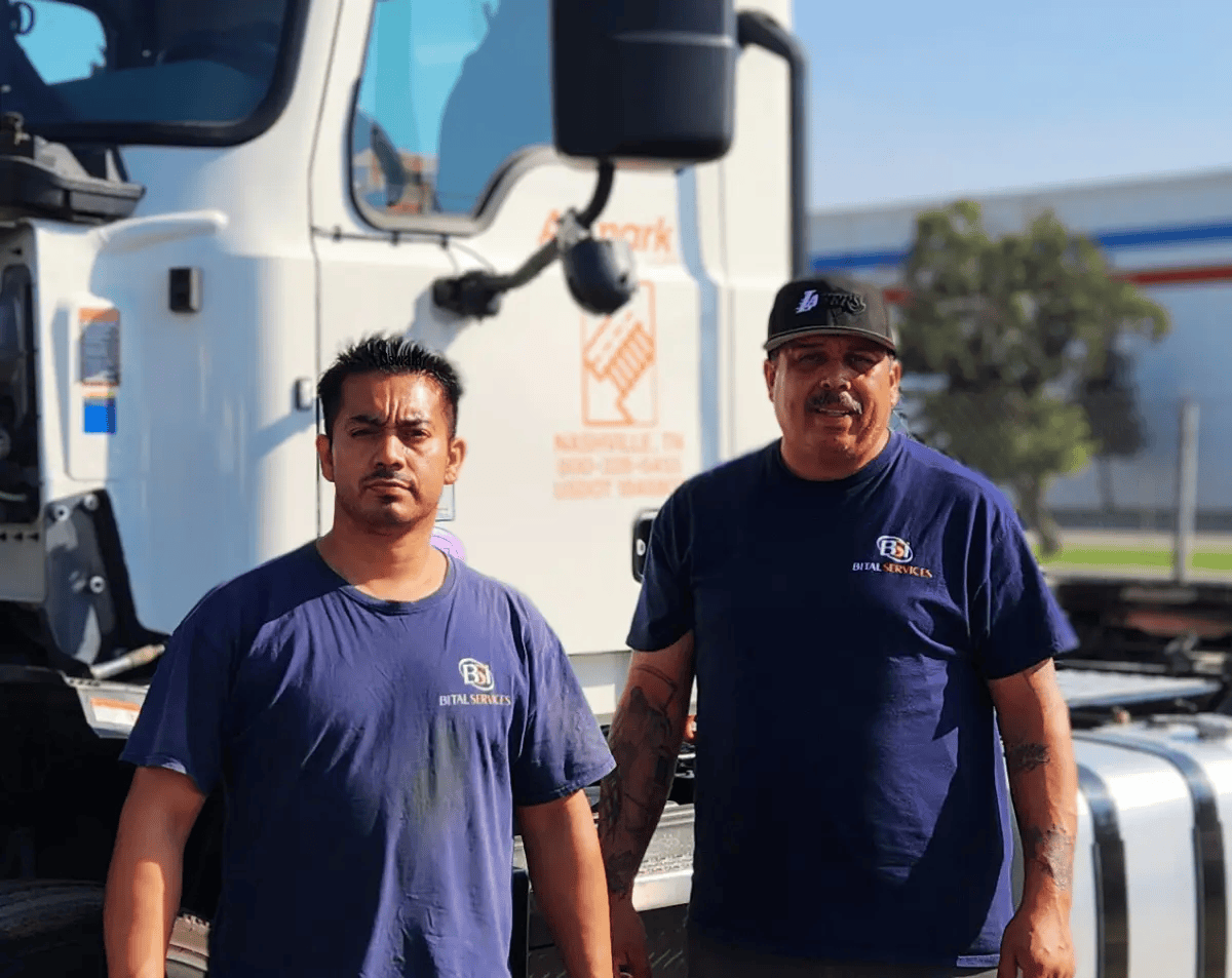 Bital Services installation technicians beside a commercial fleet truck.