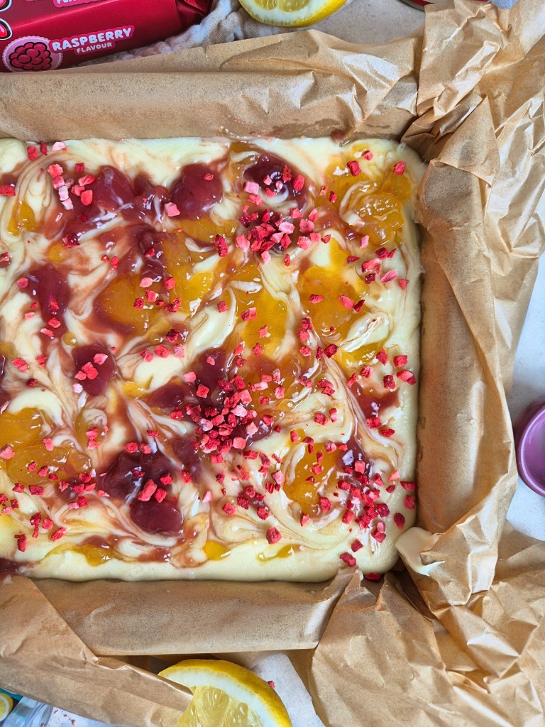 Homemade no bake lemon and raspberry slice with jam and lemon curd topping