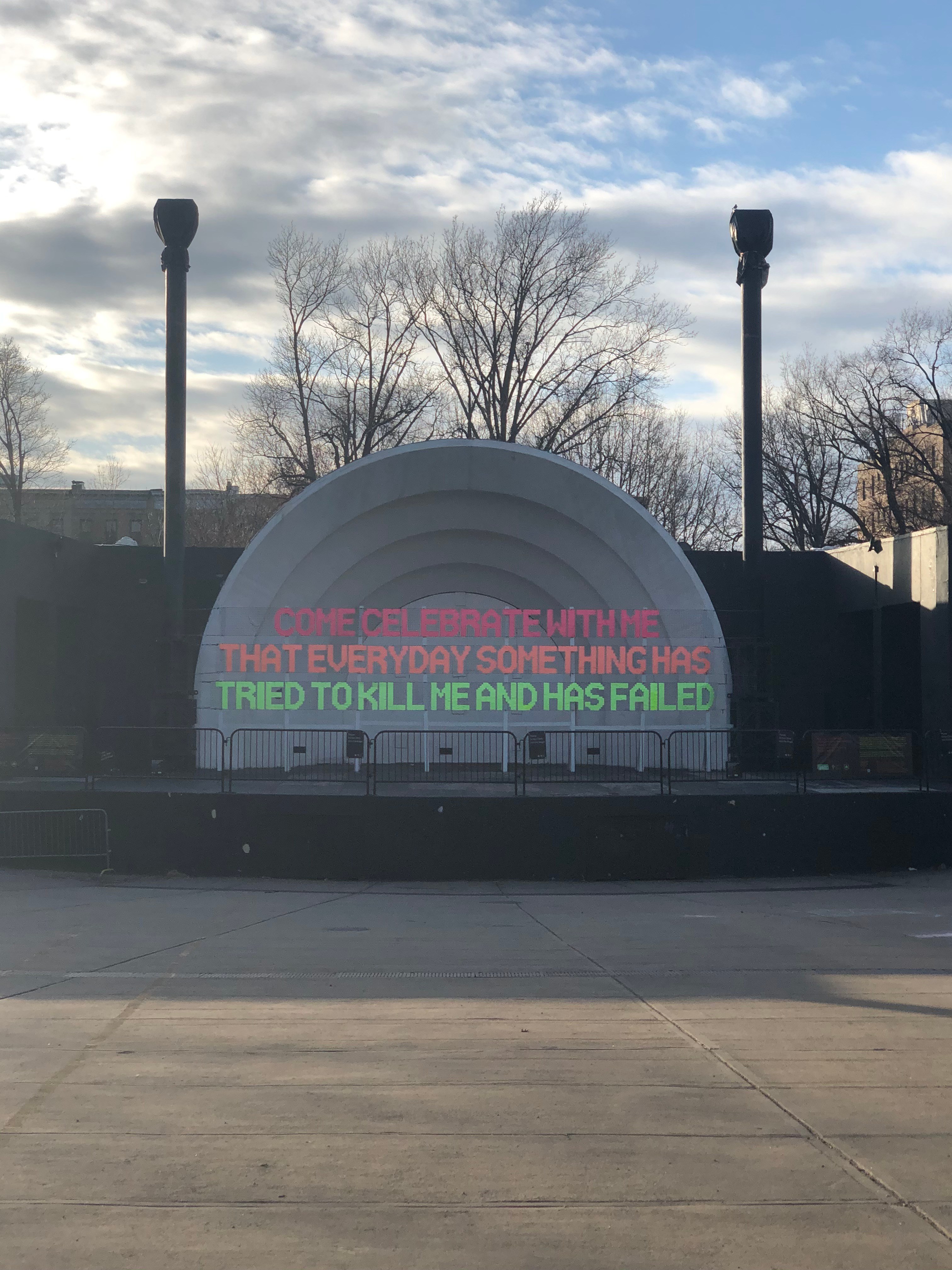 Prospect Park Bandshell in Brooklyn with a colorful resilience message painted across the stage.