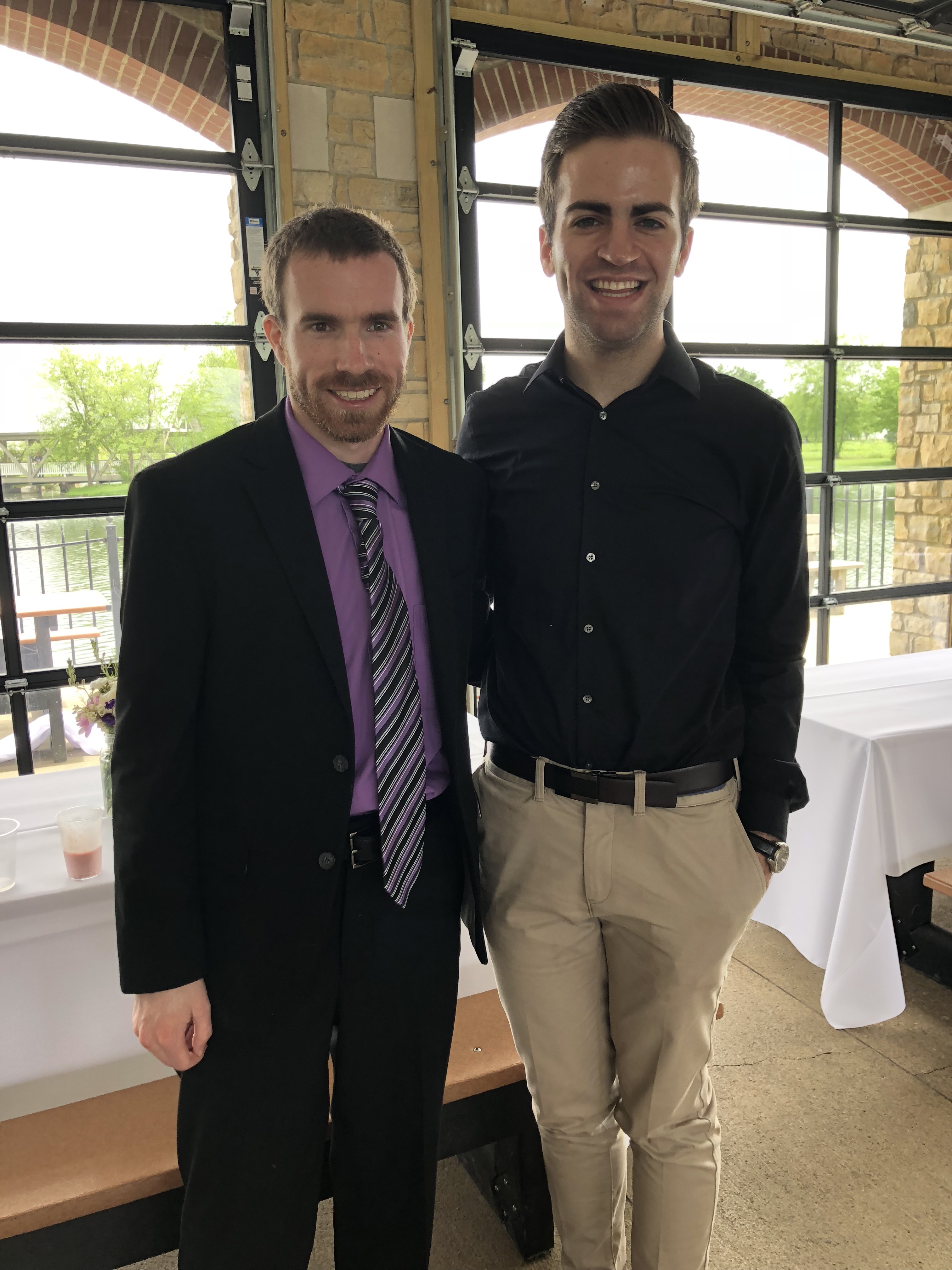 Brian and Bobby posing together at a wedding.