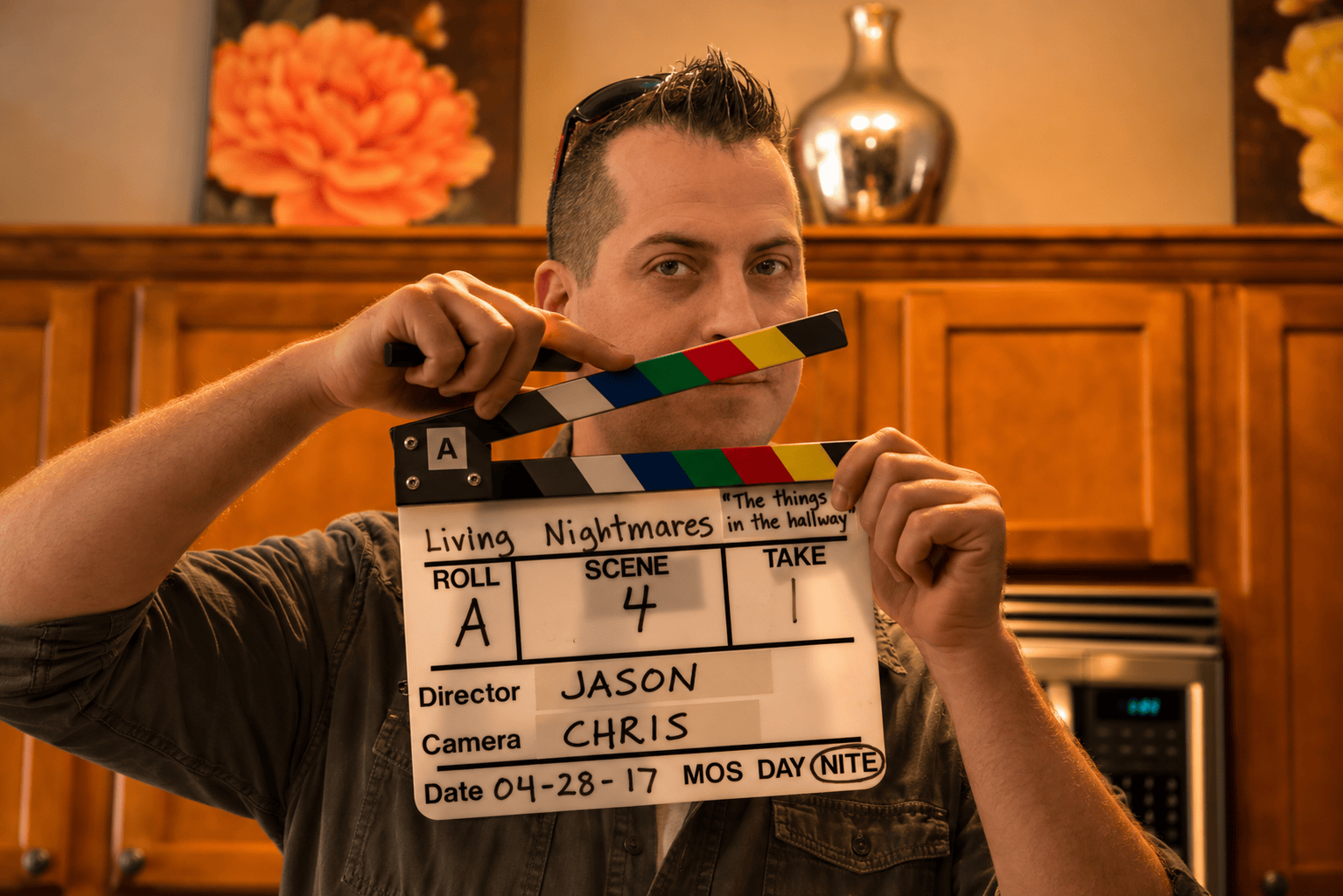 Jason Montney holding a Living Nightmares production slate