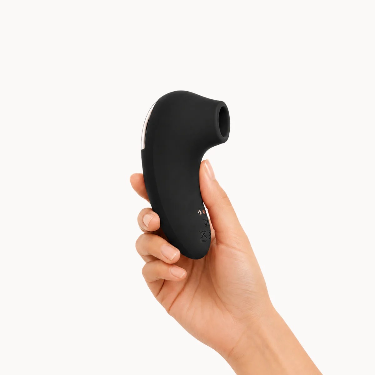 Hand showcasing Aero Bliss vibrator against a light grey background.