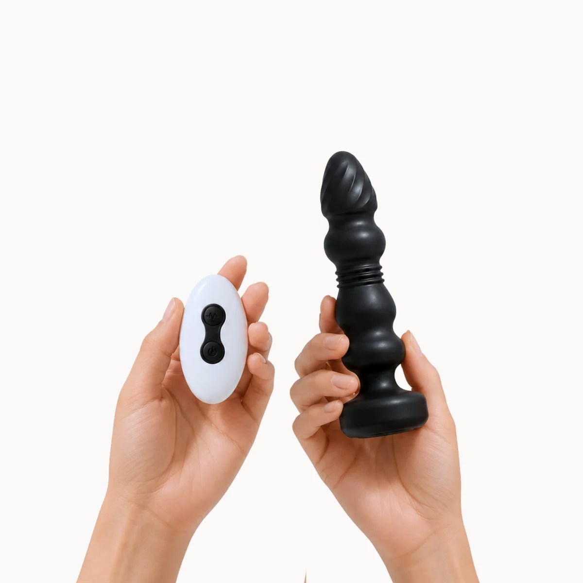 Hand showcasing BeadThrust™ anal toy against a light grey background.