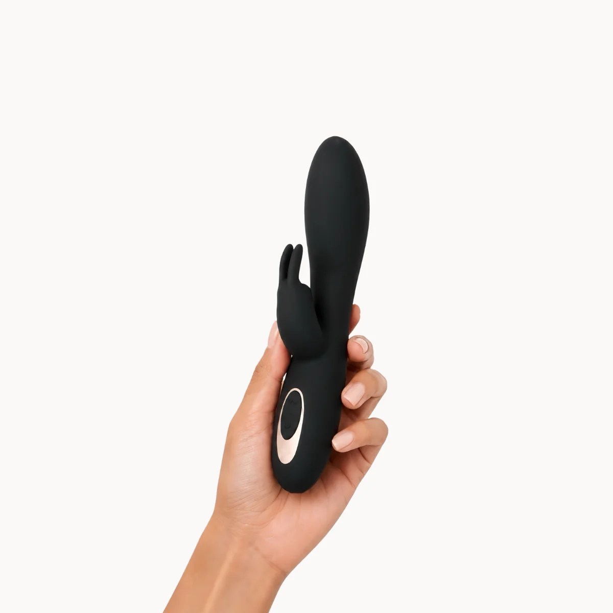 Hand showcasing Celeste vibrator against a light grey background.