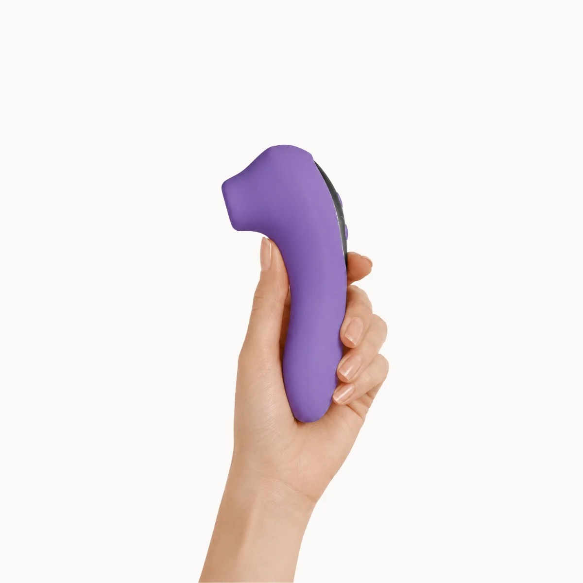 Hand showcasing Cleo Dual vibrator against a light grey background.