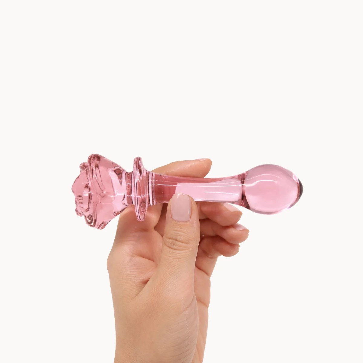 Hand showcasing Crystal Bloom anal toy against a light grey background.