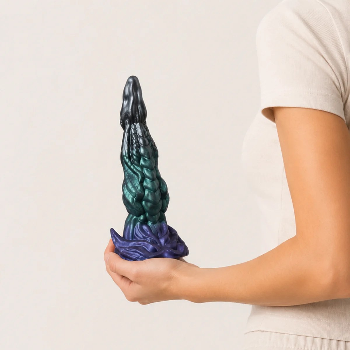 Woman showcasing Dragon Flare dildo in hand.