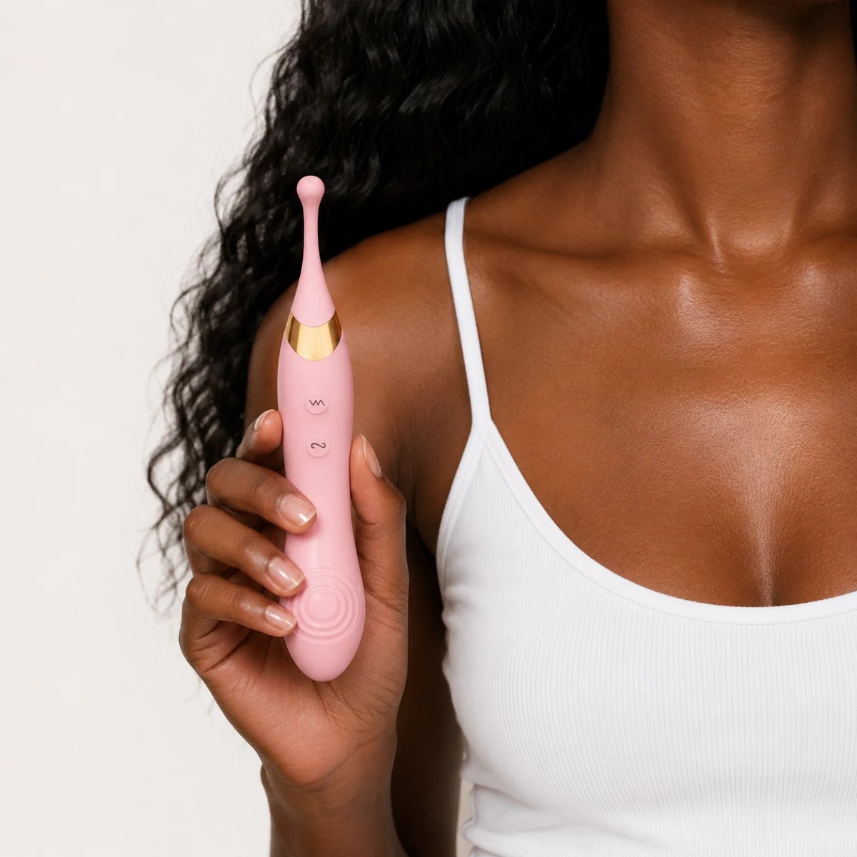 Woman showcasing DuoRush™ vibrator in hand.