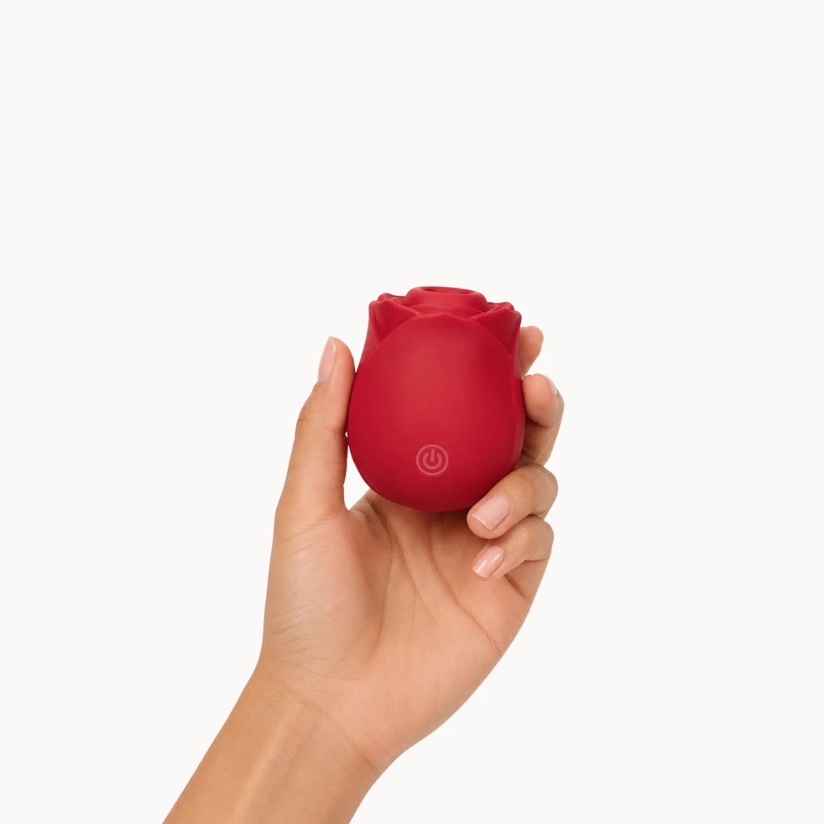 Hand showcasing Eden vibrator against a light grey background.
