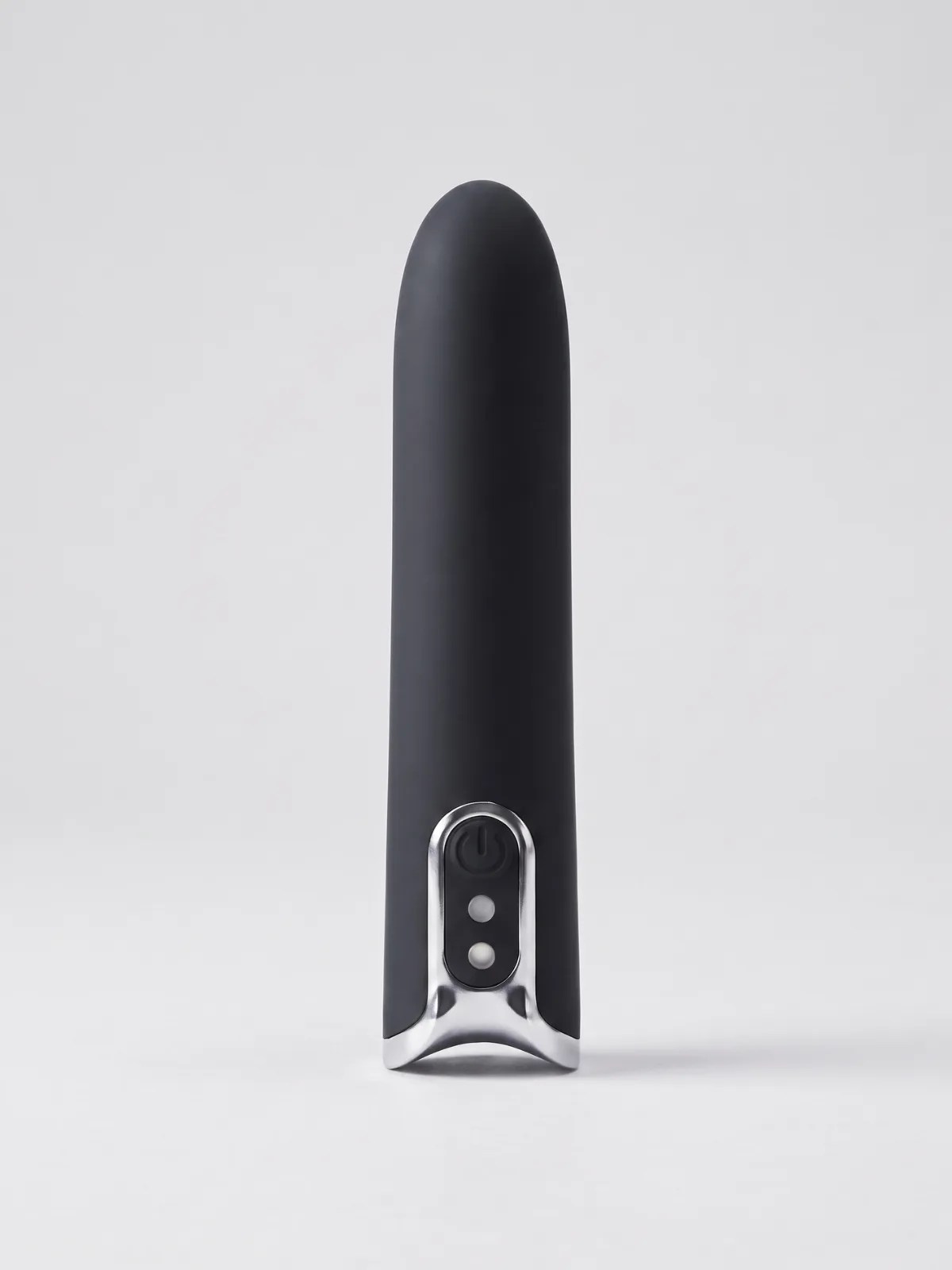 Lumi black silicone bullet vibrator shown upright, highlighting its slim design, rounded tip, and silver control panel.