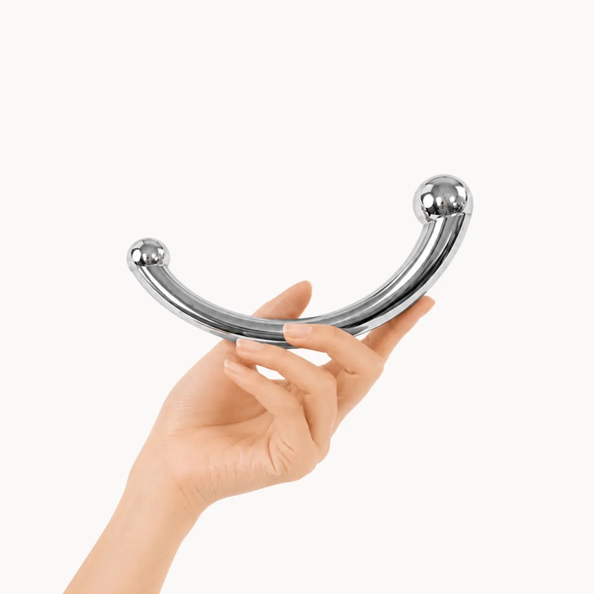 Hand showcasing Regal Pro anal toy against a light grey background.