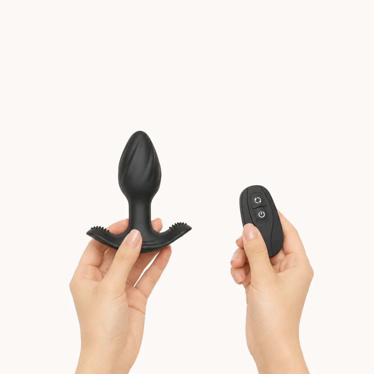 Hand showcasing Toren anal toy against a light grey background.
