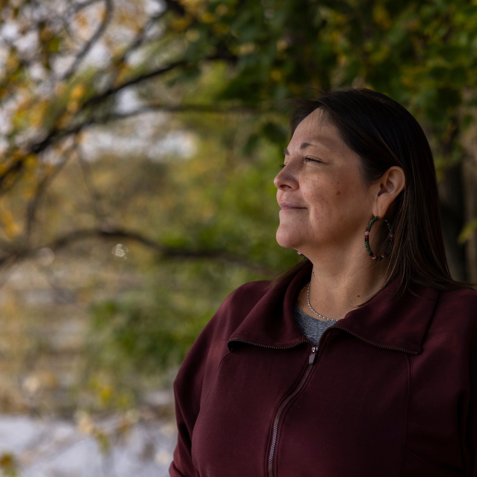 Woman in reflection symbolising eldest daughter syndrome, emotional responsibility, and generational healing