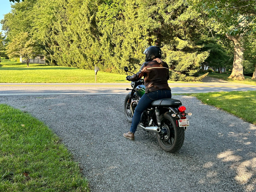 Author riding motorcycle on the uphill driveway.