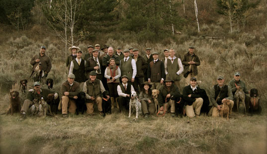 Group of handlers and their retrievers gathered for a group photo