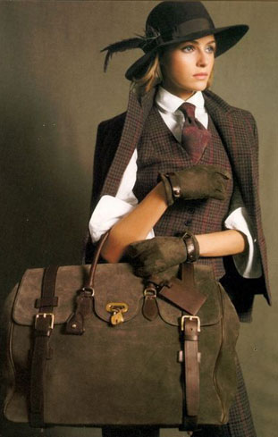 Woman in a felt hat and tweed shooting jacket holding a canvas bag