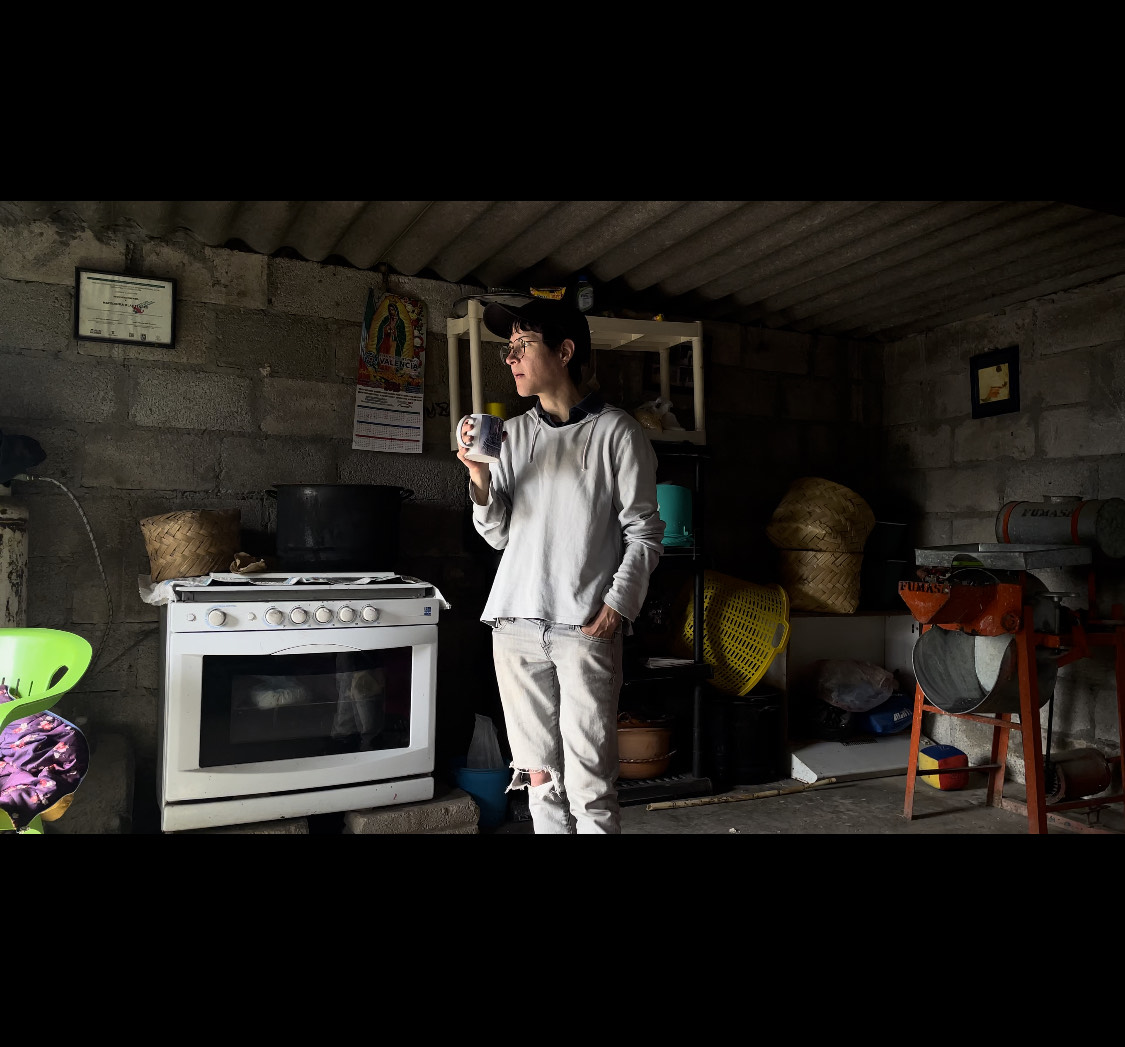 Picture of person, dressed in white, in a garage type structure