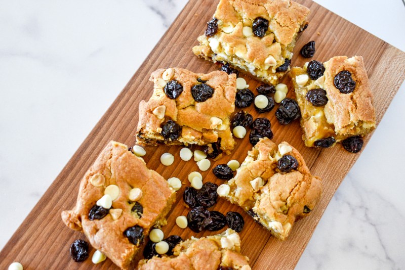 Cherry blondies on a wooden serving board
