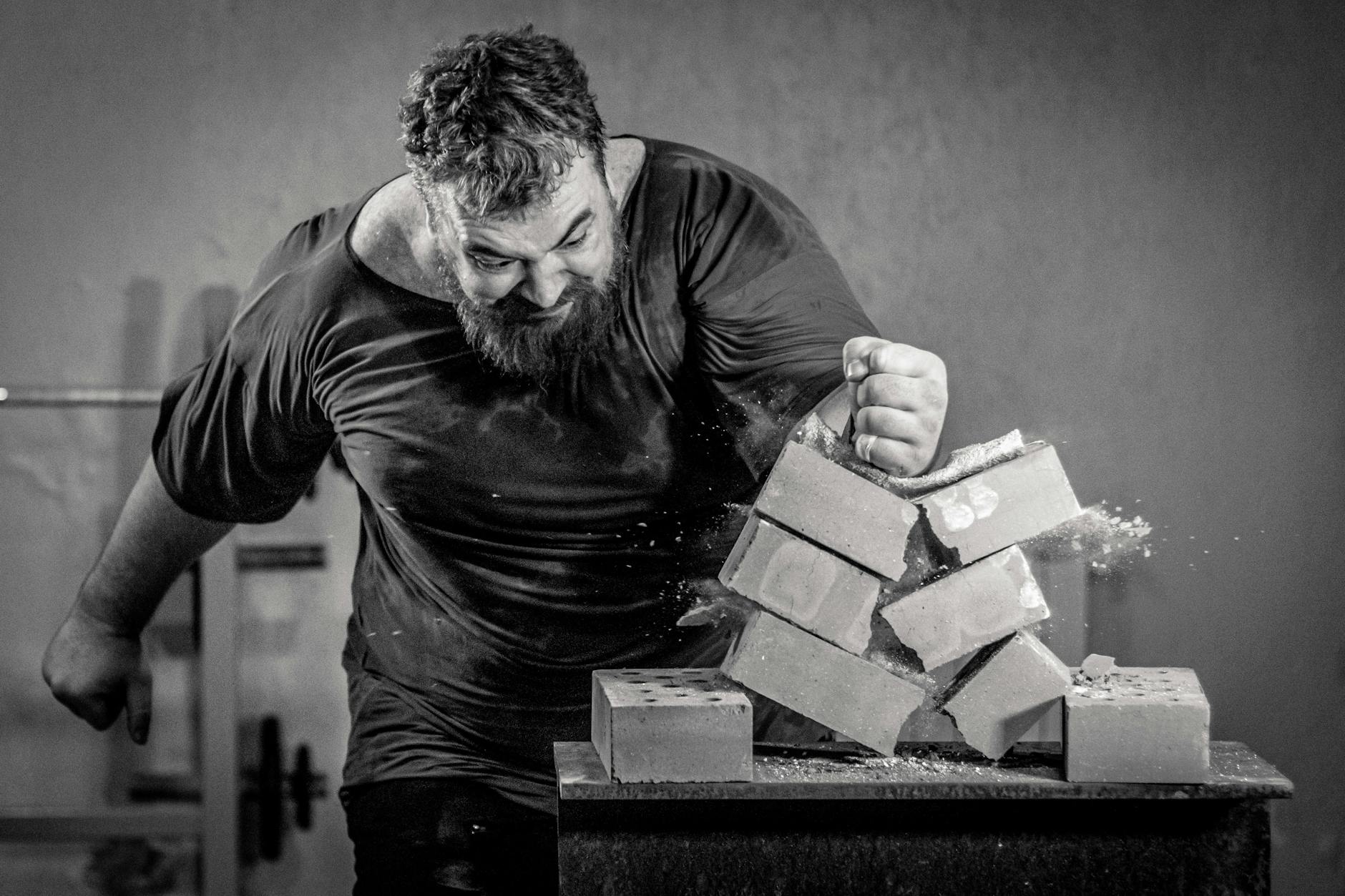 a man breaking concrete block using his hand