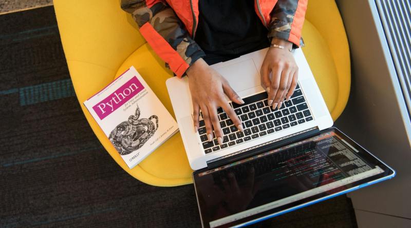 woman programming on a notebook