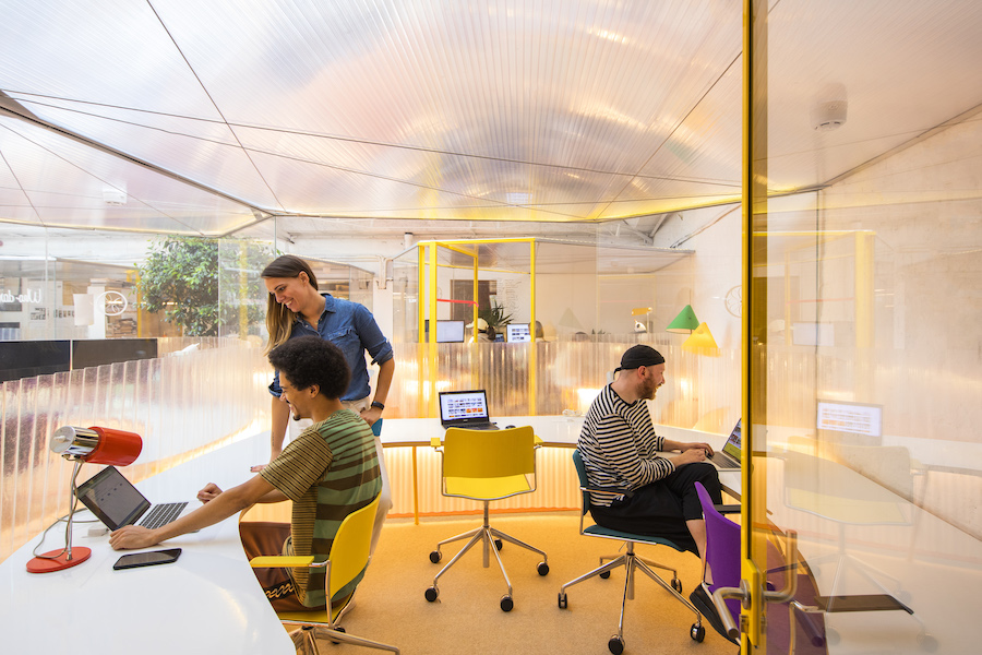 Knowledge-based workers on their laptops in a cosy corner in Second Home's coworking space