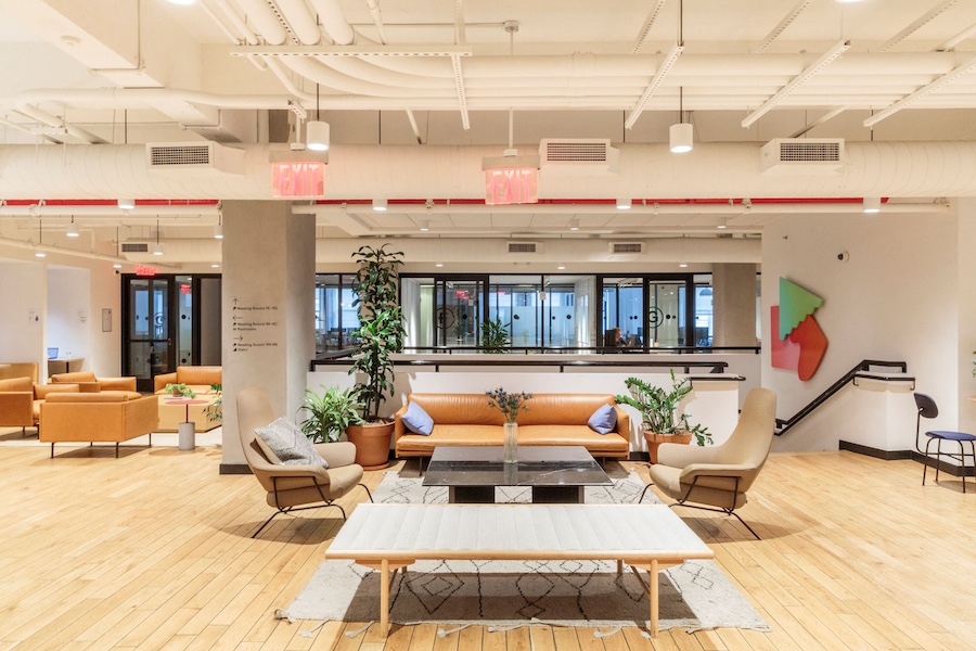 Midtown Manhattan office at WeWork 500 7th Avenue, featuring Art Deco design elements, private offices, communal lounges, and meeting rooms.