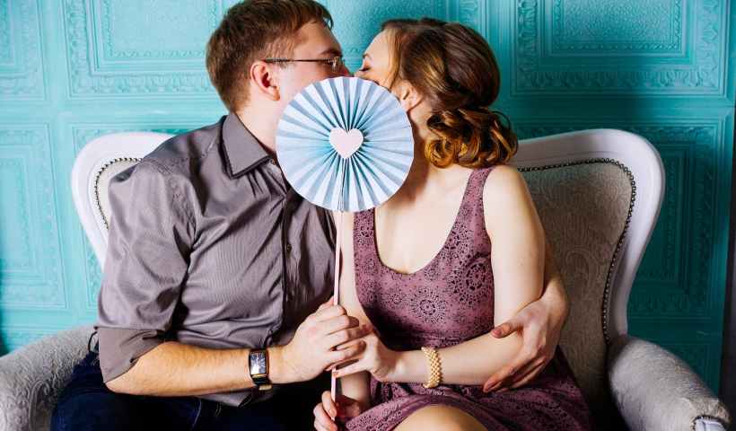 woman and man sitting on grey suede loveseat