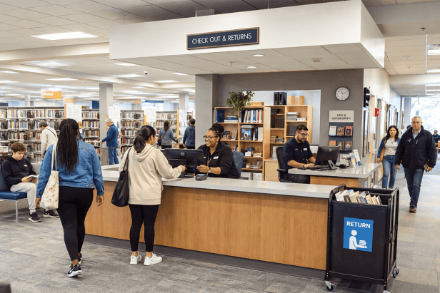 A Town Square® drop ceiling sign indicates where library patrons can check-out and return books with a librarian.