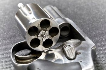 Revolver with open cylinder ready for armed good guys