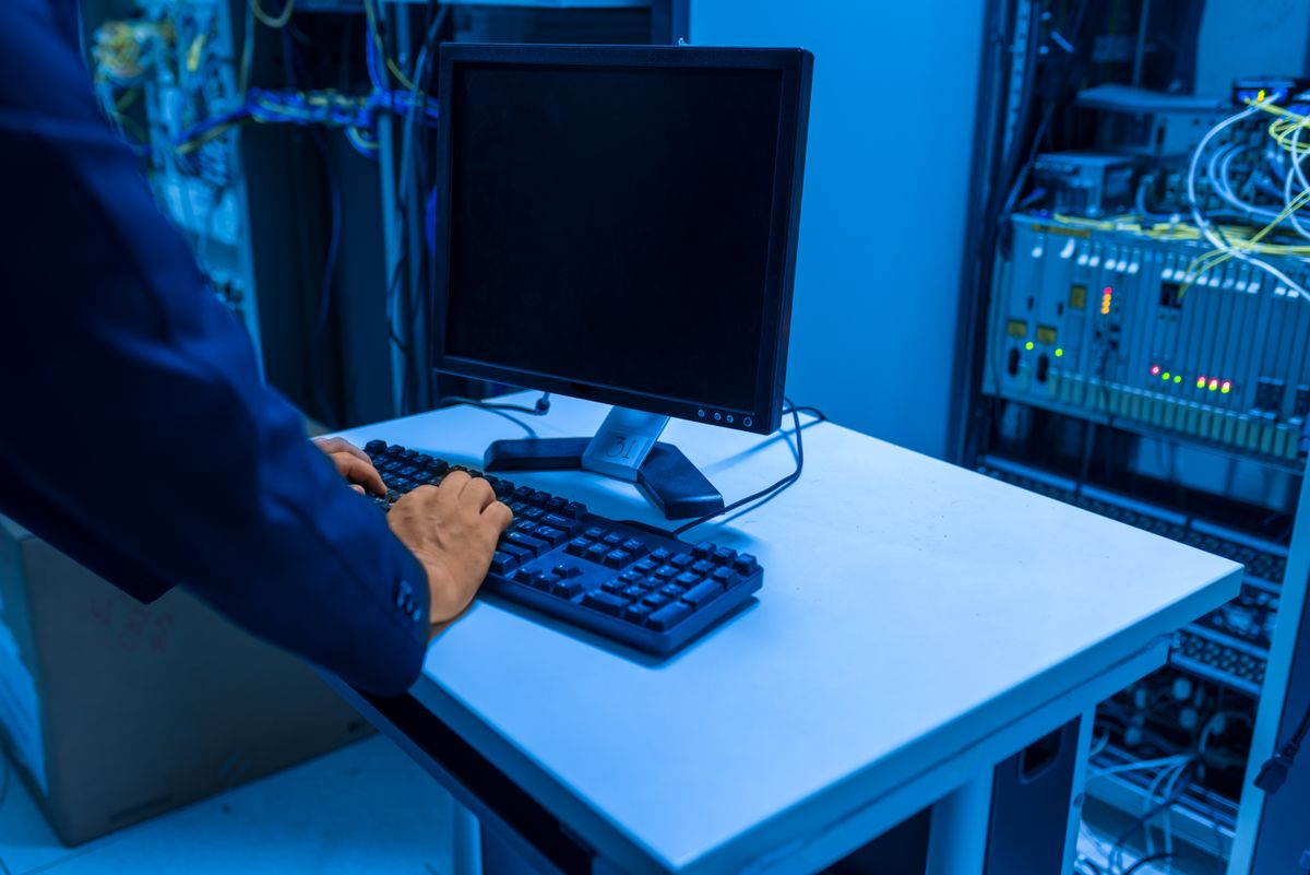 IT specialist working in a server room during a ransomware response review