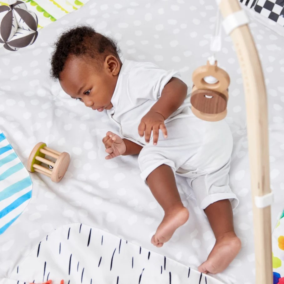 Baby rolling on The Play Gym by Lovevery