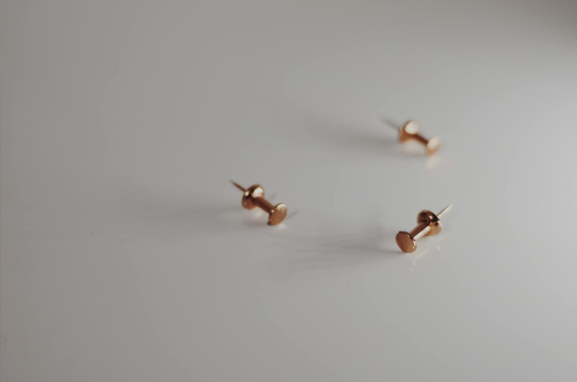 three gold tacks
