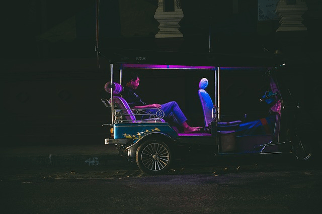 A tuk tuk standing on the road