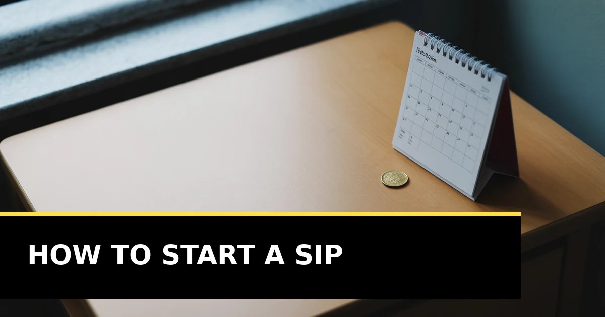 A wall calendar and a small gold coin on a pale desk, photographed from above in soft daylight