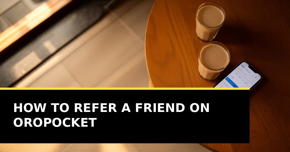 Two cups of chai on a wooden table beside a phone, photographed from above in warm daylight