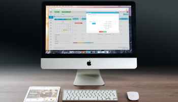 silver imac apple magic keyboard and magic mouse on wooden table