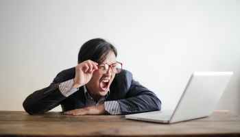 yelling formal man watching news on laptop