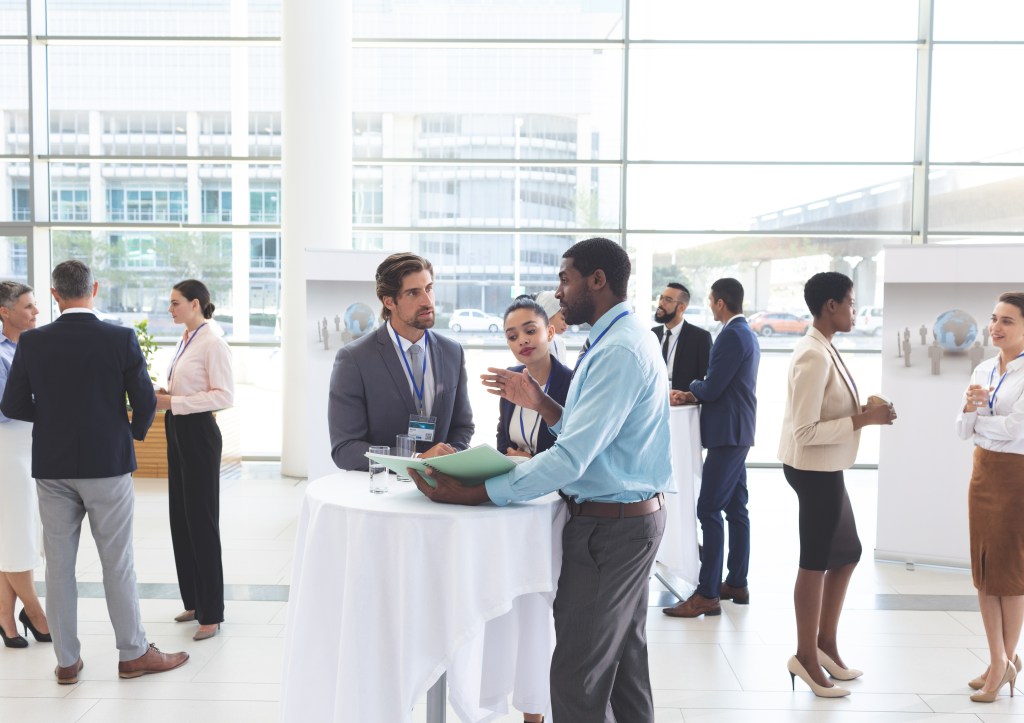 Business people discussing over documents at table during a semi