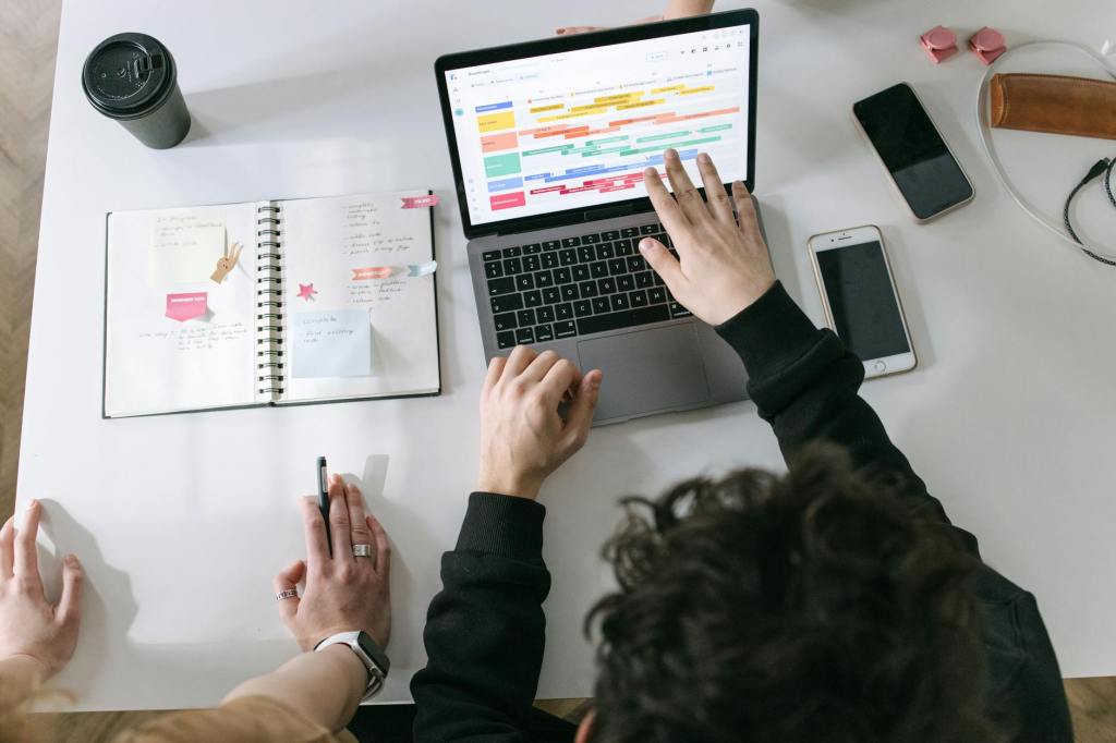 Real Estate agent looking at calendar on their computer writing notes