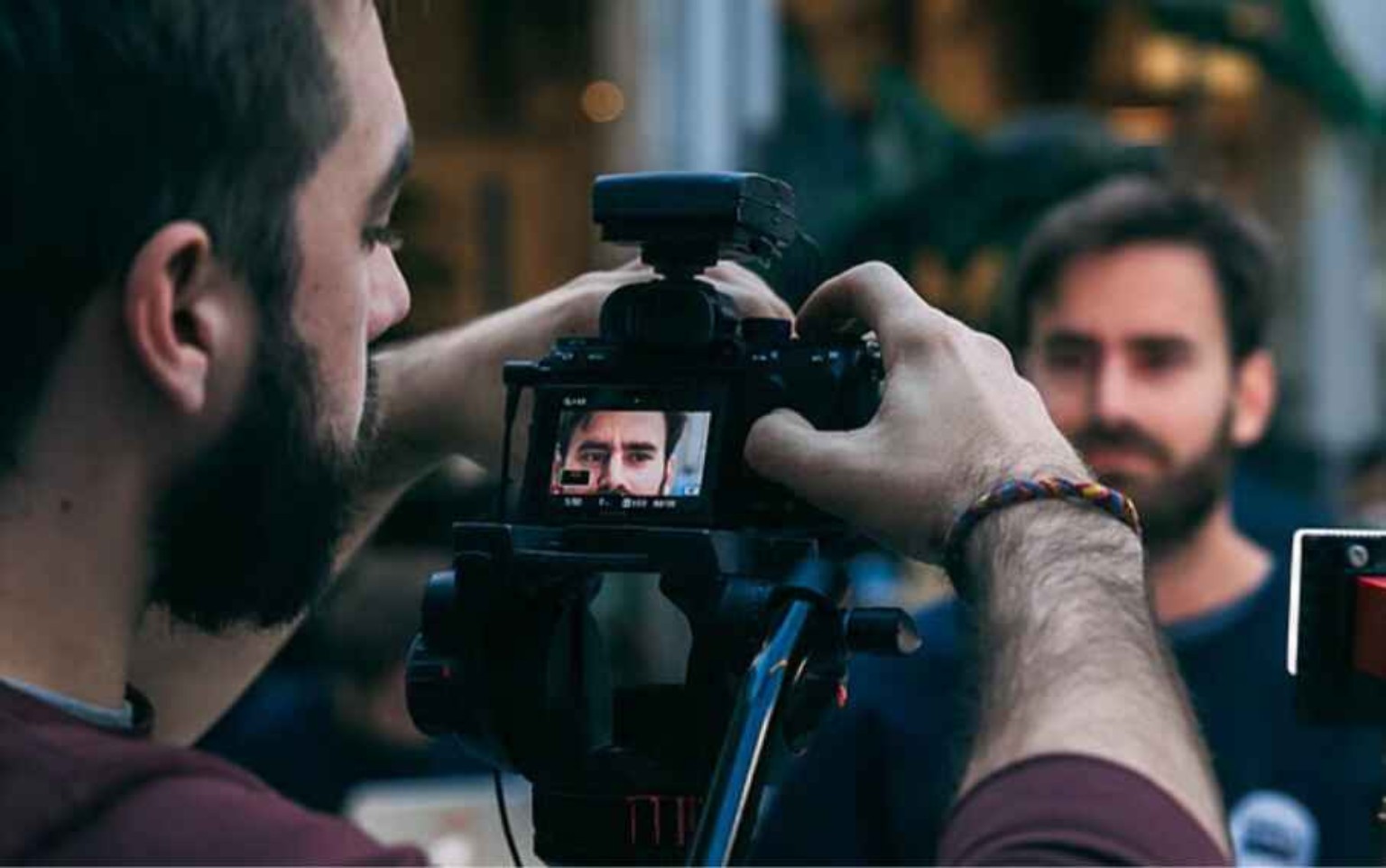 Filmmaker recording a scene with professional camera for OTT film submission requirements